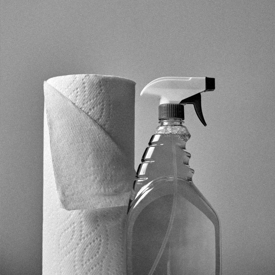 A spray bottle and roll of paper towels. TK Supplies and Packaging, Co. serves the home care industry by providing closures and home care product packaging.